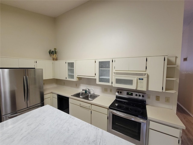 kitchen featuring white cabinetry, backsplash, dark hardwood / wood-style floors, appliances with stainless steel finishes, and sink