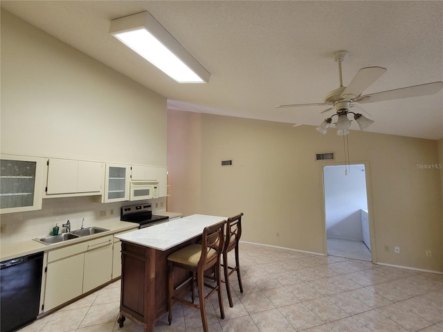 kitchen with black dishwasher, light tile floors, and stainless steel electric stove