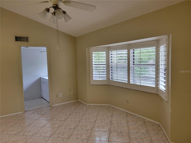 tiled empty room with lofted ceiling and ceiling fan