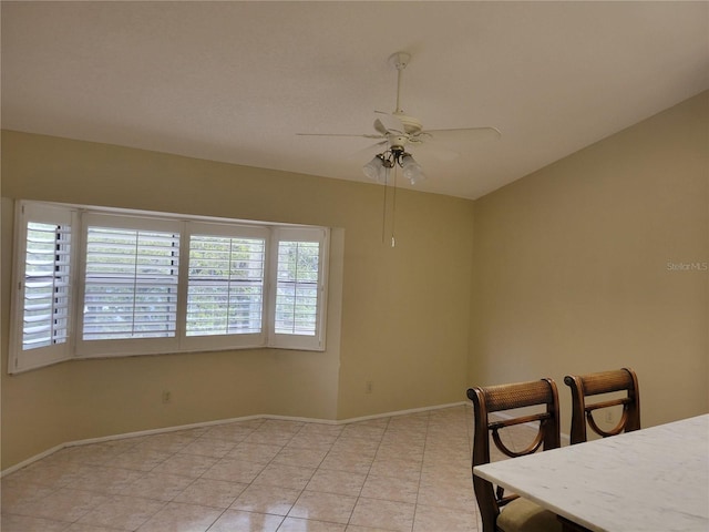 unfurnished dining area featuring light tile floors and ceiling fan