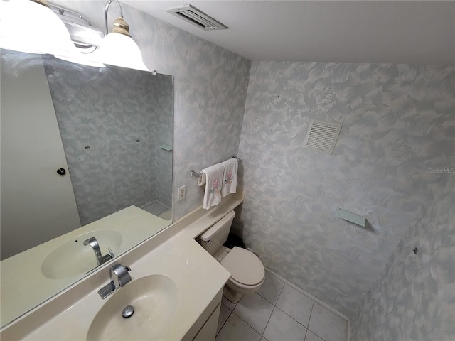 bathroom with vanity, tile floors, and toilet