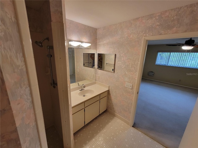 bathroom with oversized vanity, ceiling fan, and walk in shower