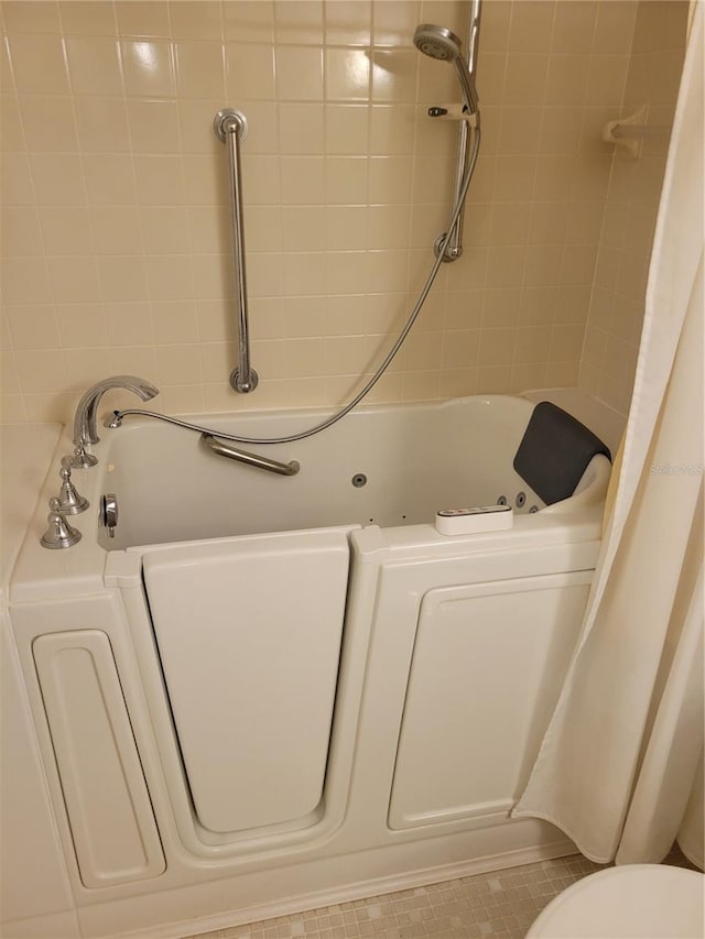 bathroom featuring toilet, shower / tub combo, and tile floors