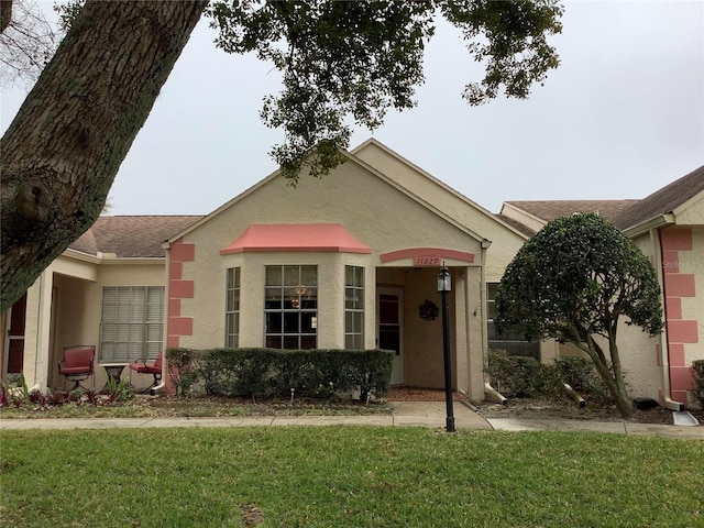 ranch-style home with a front lawn