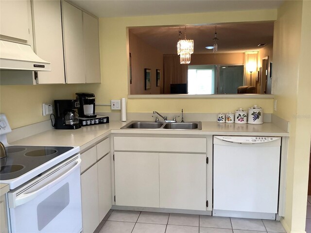 kitchen featuring white cabinetry, hanging light fixtures, white appliances, a notable chandelier, and sink