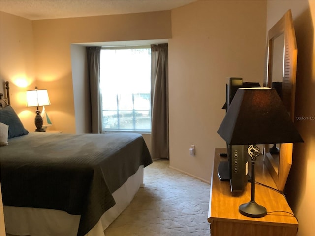 bedroom featuring light colored carpet