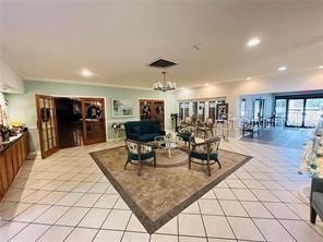 living room with a notable chandelier and light tile floors