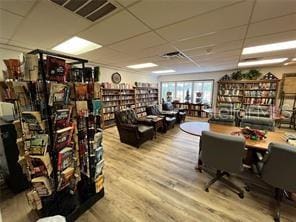 home office featuring a drop ceiling and light wood-type flooring