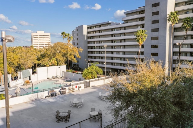 view of building exterior featuring a community pool