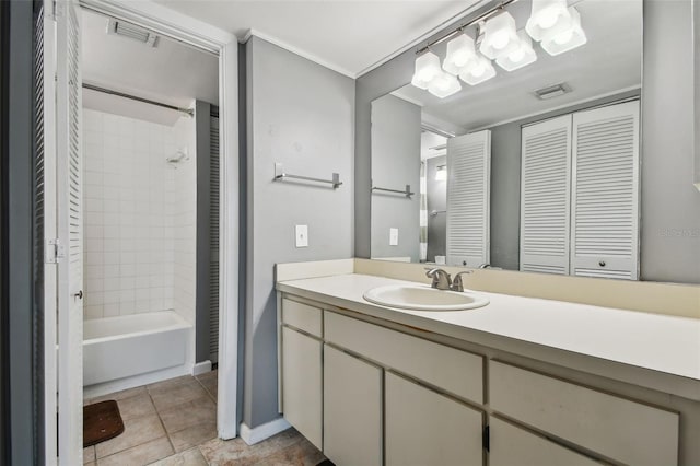 bathroom with vanity, tile floors, and tiled shower / bath