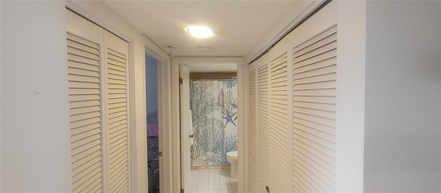 hall featuring light tile patterned floors