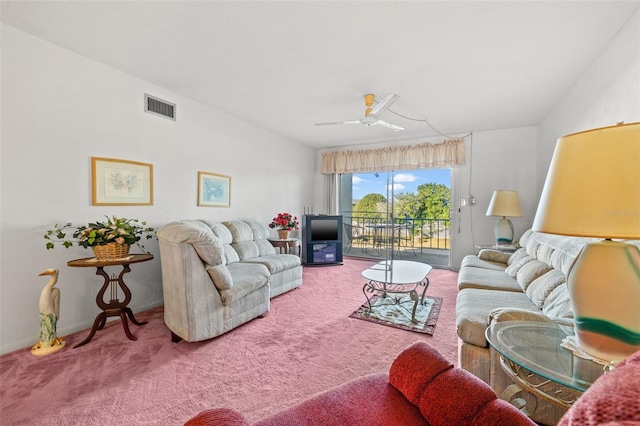 carpeted living room with ceiling fan