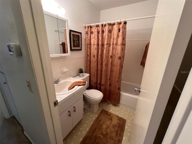 full bathroom featuring tile walls, vanity, tile patterned flooring, shower / tub combo with curtain, and toilet