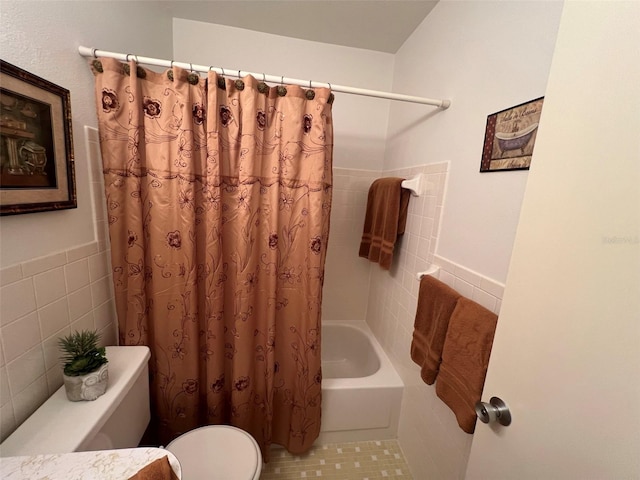 bathroom featuring shower / bath combination with curtain, tile walls, tile patterned floors, and toilet