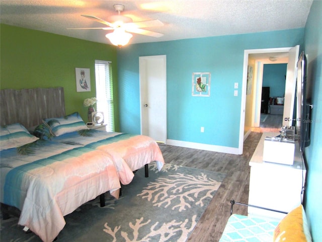 bedroom featuring a textured ceiling, ceiling fan, and wood-type flooring