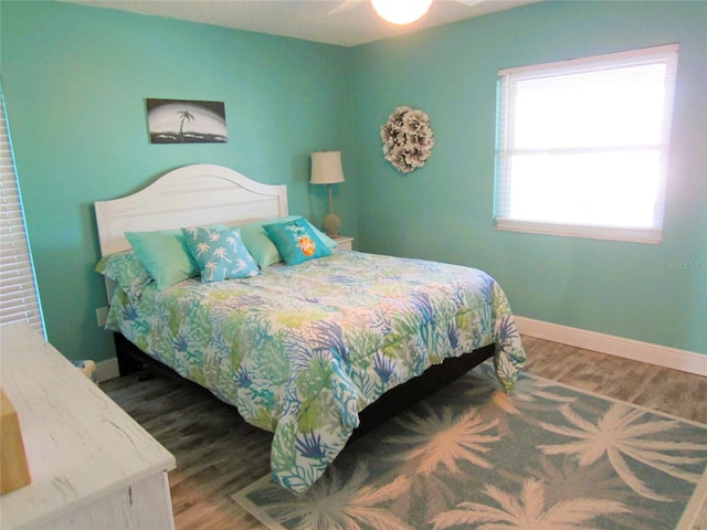 bedroom with ceiling fan and hardwood / wood-style floors