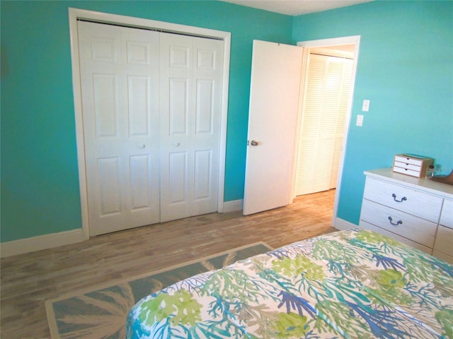 bedroom with a closet and hardwood / wood-style flooring