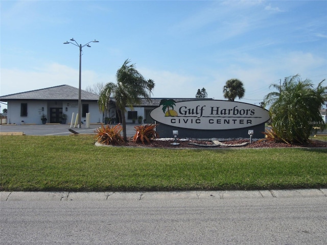 community sign featuring a lawn