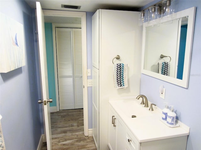 bathroom featuring hardwood / wood-style flooring and vanity