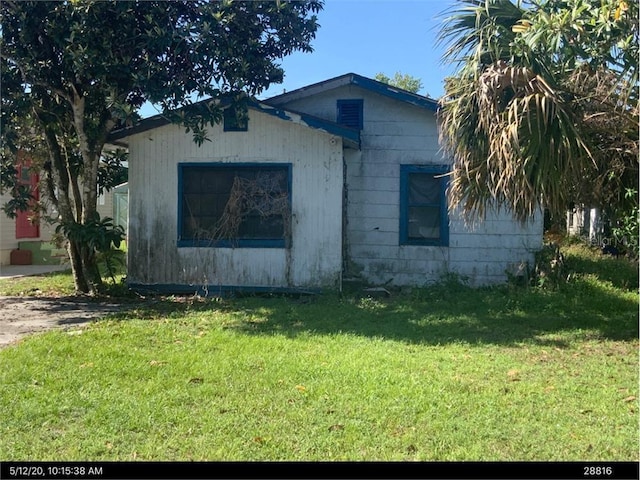 view of property exterior with a lawn