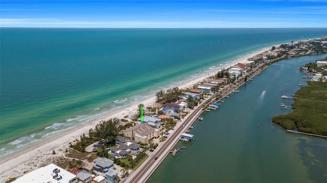 bird's eye view featuring a water view and a beach view