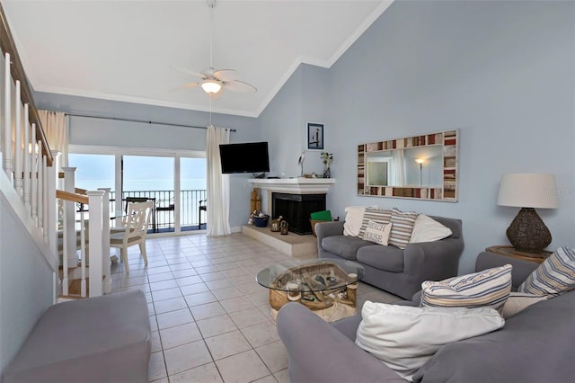 living room with light tile patterned floors, high vaulted ceiling, ceiling fan, and ornamental molding