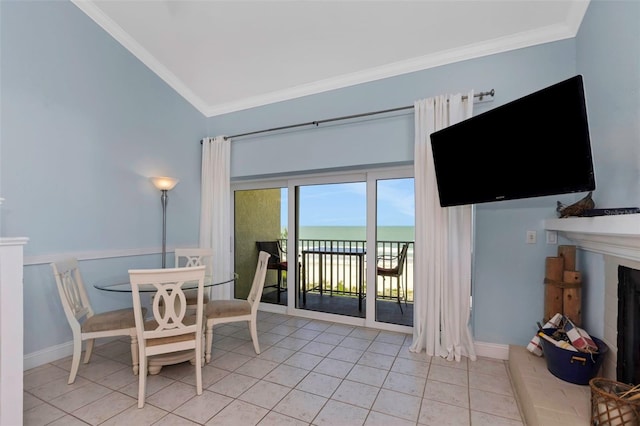 tiled dining space with lofted ceiling and ornamental molding