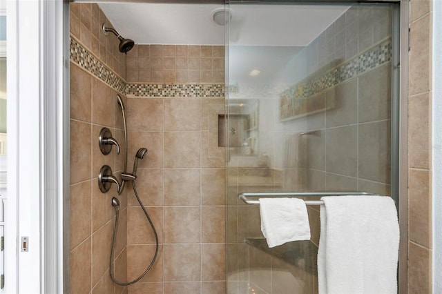 bathroom with a shower with shower door