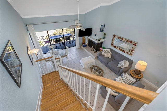 living room featuring ceiling fan, crown molding, and light hardwood / wood-style floors