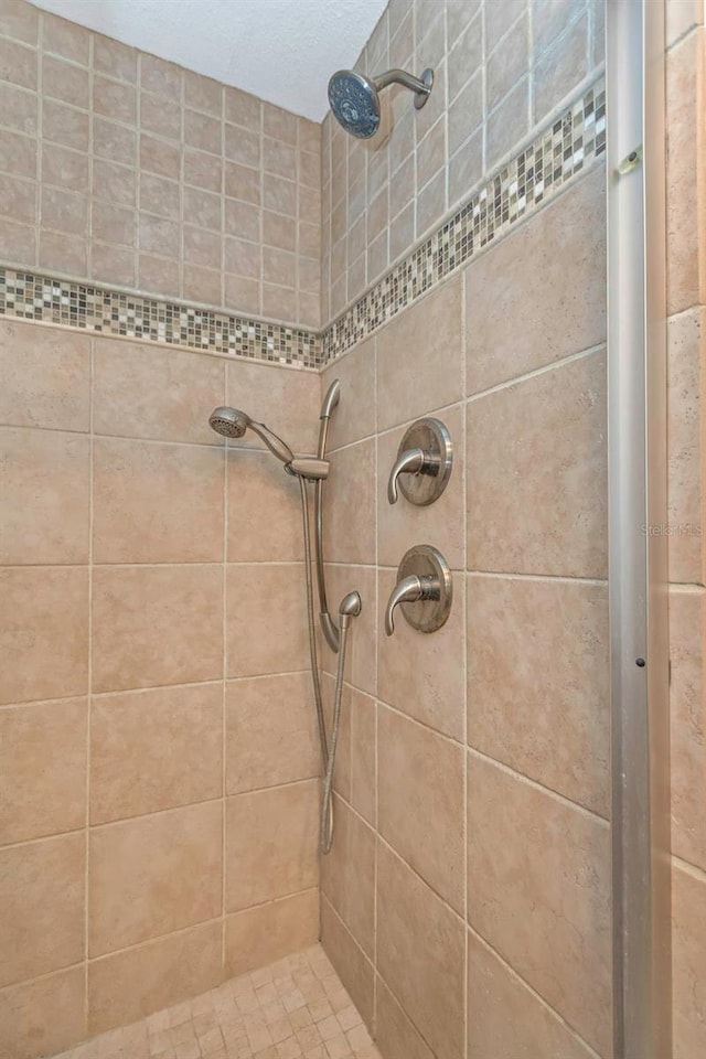 bathroom with tiled shower