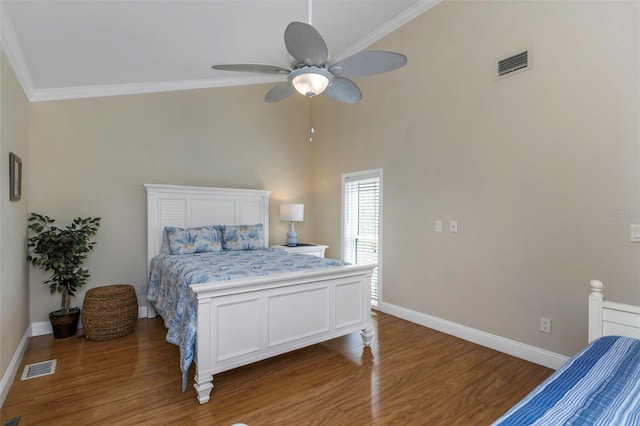 bedroom featuring ceiling fan, ornamental molding, and dark wood-type flooring