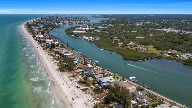 birds eye view of property featuring a water view and a beach view