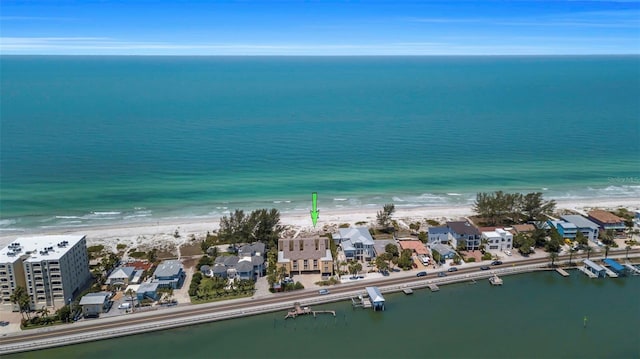 bird's eye view featuring a water view and a beach view