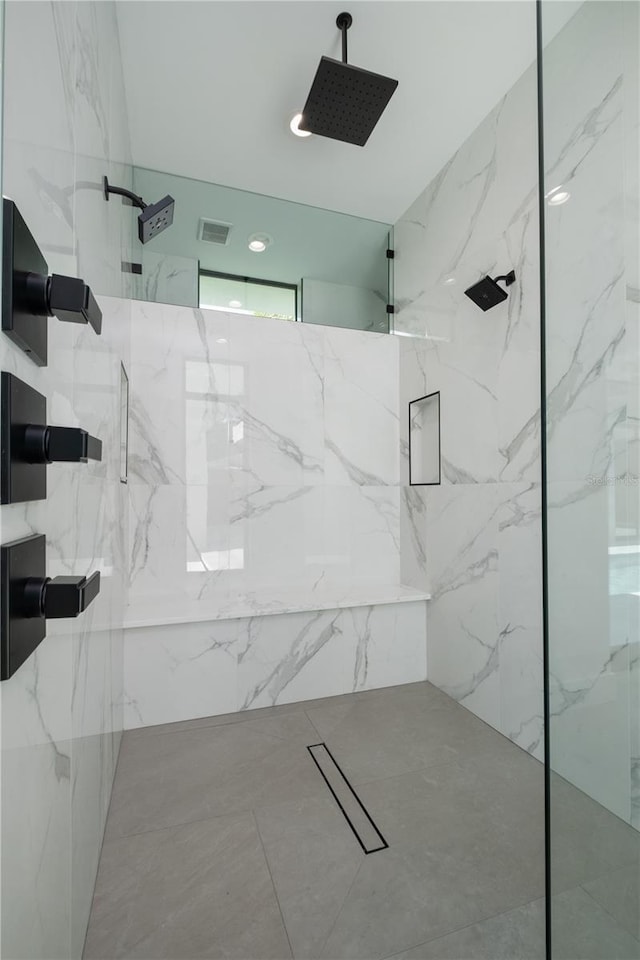 bathroom with a tile shower