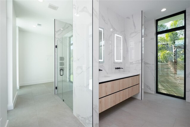 bathroom featuring vanity and a shower with shower door