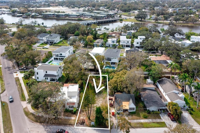 drone / aerial view with a water view and a residential view