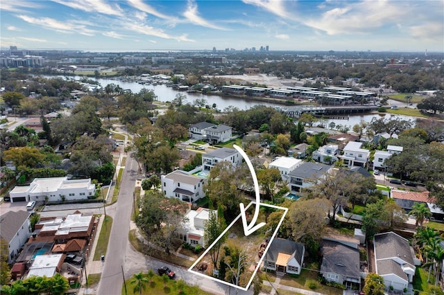 birds eye view of property with a water view and a residential view