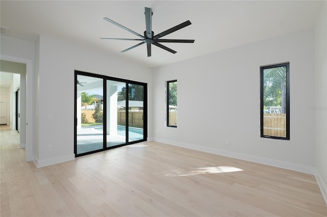 unfurnished room featuring ceiling fan, light wood finished floors, and baseboards