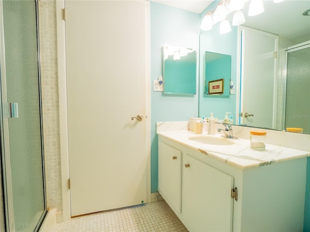 bathroom featuring walk in shower, tile floors, and vanity