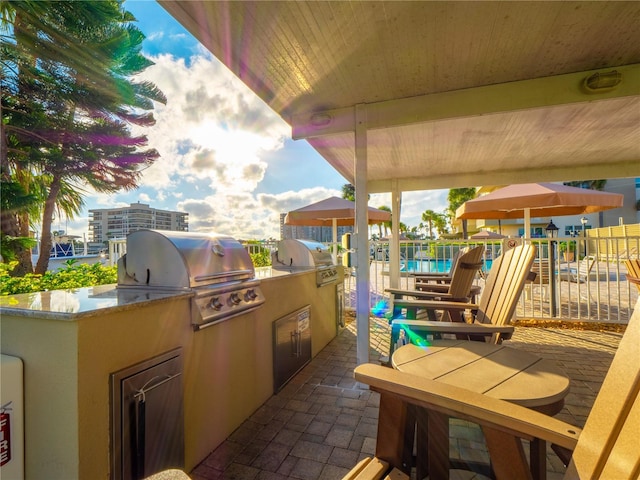 view of patio / terrace featuring an outdoor kitchen and a grill