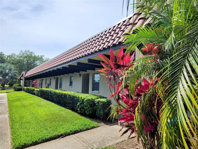 view of property exterior with a lawn