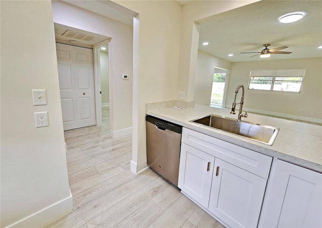 kitchen with sink, dishwasher, ceiling fan, light hardwood / wood-style floors, and white cabinets