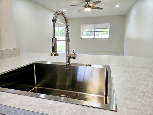 interior details with sink and ceiling fan