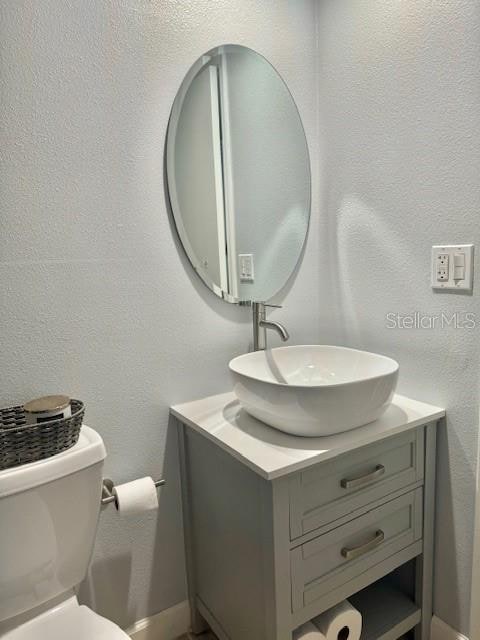 bathroom with oversized vanity and toilet