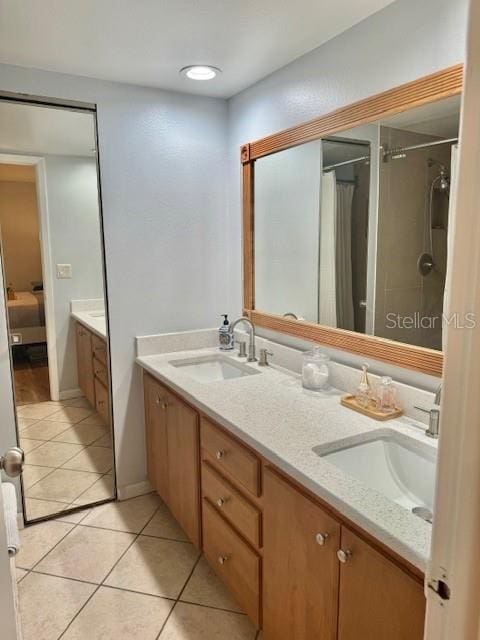 bathroom with double vanity, tile flooring, and curtained shower