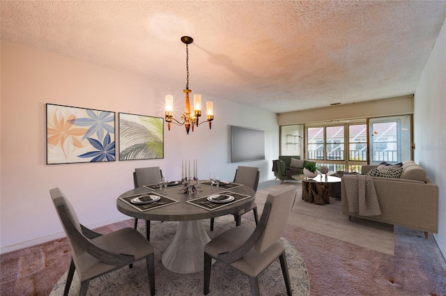 dining space featuring a notable chandelier, a textured ceiling, and carpet