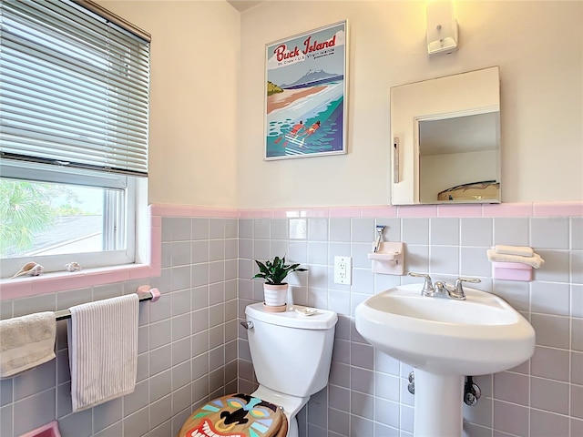 bathroom featuring backsplash, toilet, and tile walls