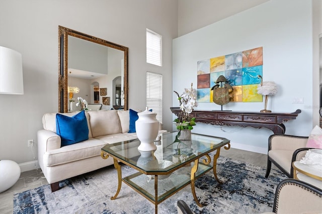 tiled living room featuring a towering ceiling