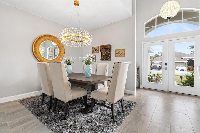 dining room featuring an inviting chandelier and french doors