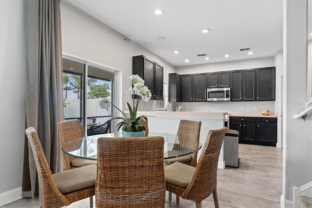 tiled dining room with sink